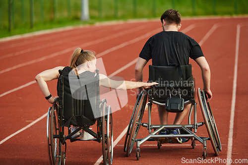 Image of An inspiring couple with disability showcase their incredible determination and strength as they train together for the Paralympics pushing their wheelchairs in marathon track