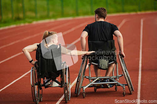 Image of An inspiring couple with disability showcase their incredible determination and strength as they train together for the Paralympics pushing their wheelchairs in marathon track