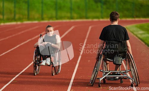 Image of An inspiring couple with disability showcase their incredible determination and strength as they train together for the Paralympics pushing their wheelchairs in marathon track