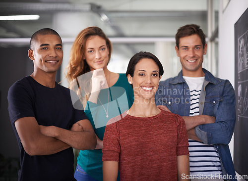 Image of Positive about work. Cropped portrait of a team of young creative professionals standing in the office.