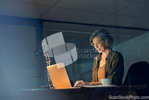 Image of You need a tireless work ethnic to succeed. Cropped shot of a mature businesswomen working late on a laptop in an office.