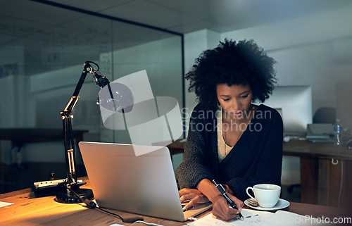 Image of Powering through to knockout her deadlines. Cropped shot of a young businesswoman working late on a laptop in an office.