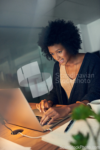 Image of Just editing the last few details before heading home. Cropped shot of a young businesswoman working late on a laptop in an office.