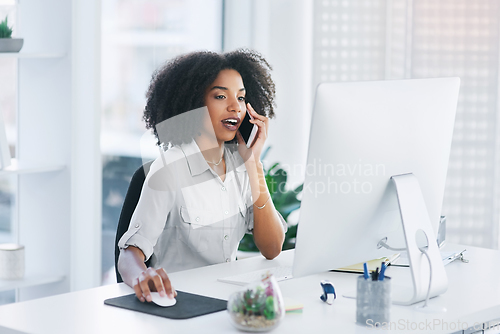 Image of Let me just open the document on my pc.... Shot of a young businesswoman talking on a cellphone in an office.