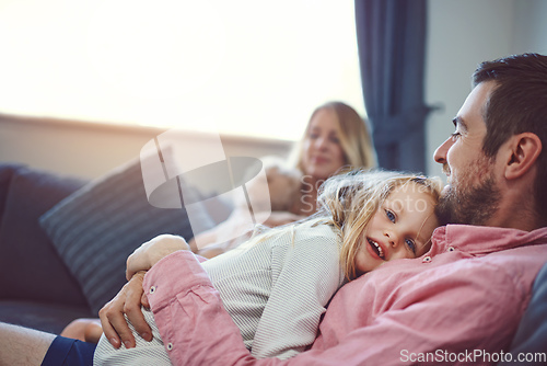 Image of Love them, nurture them, care for them. Shot of an adorable young family of four relaxing together on the sofa at home.