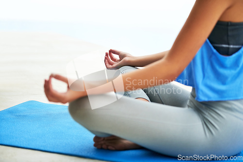 Image of Find your zen in ever situation. Cropped shot of a young woman practising the lotus pose.
