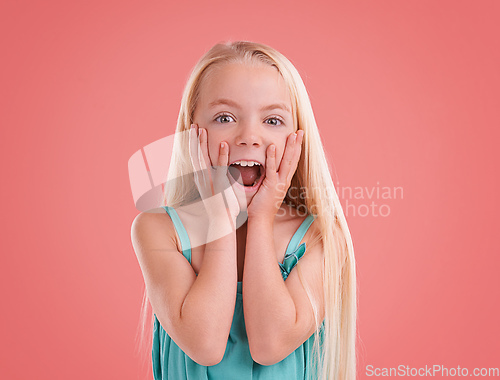 Image of Look at that.... Studio shot of a young girl posing on an orange background.