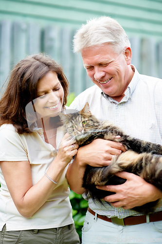 Image of Hes like a member of the family. Cropped shot of a senior couple with their cat outdoors.