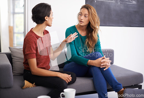 Image of Theyre working together on an exciting project. Shot of two female professionals having a discussion in an informal office setting.