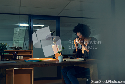 Image of Shes got a strong cuppa to keep her going. Cropped shot of a young businesswoman working late on a laptop in an office.