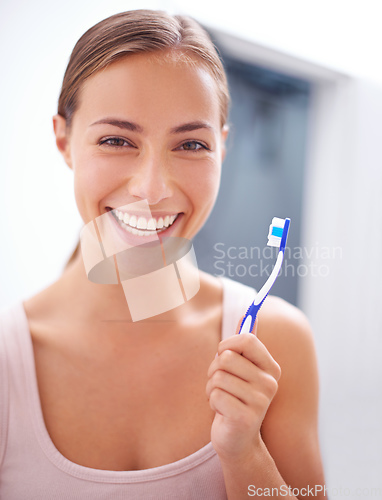 Image of Taking care of her smile. A young woman brushing her teeth.