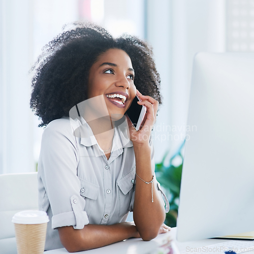 Image of She loves getting positive feedback from clients. Shot of a young businesswoman talking on a cellphone in an office.