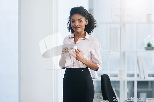 Image of Taking a quick break before heading back to work. Portrait of a young businesswoman drinking a cup of coffee in an office.