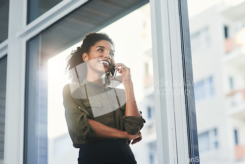 Image of Exciting prospects on the horizon. Shot of a young businesswoman making a phone call in her office.