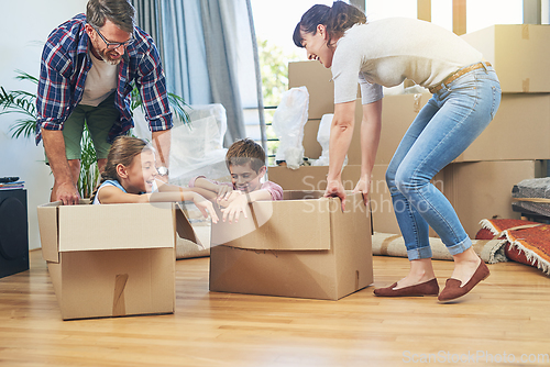 Image of Making moving day a family friendly activity. Shot of a happy family having fun together on moving day.