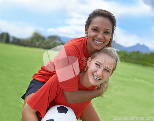Image of Best friends and teammates. Shot of a female soccer player carrying her teammate on her back.