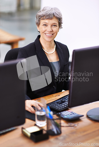 Image of She always has a smile on her face. Portrait of a mature woman sitting in an office.