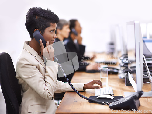 Image of Pushing hard to reach their targets. Shot of three businesswomen working in an office.