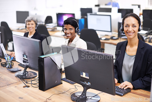 Image of Theyre the best team in the call center. Cropped shot of three female call center representatives wearing headsets.