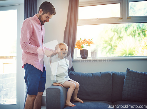 Image of Not a hair out of place when dad does it. Shot of a father brushing his daughters hair at home.