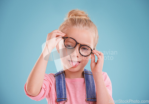 Image of These glasses are so funny. Studio shot of a little girl wearing hipster glasses on a blue background.