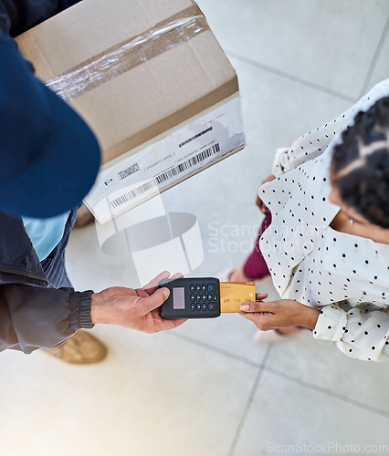 Image of For your convenience. High angle shot of an unrecognizable delivery man receiving payment from a female customer for her order.