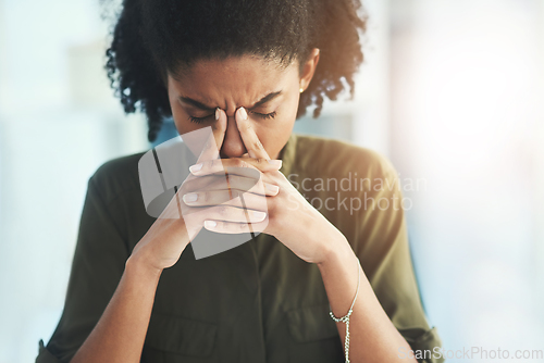 Image of Some days evidently bring no solutions to your problems. Shot of a young businesswoman looking overly stressed in her office.