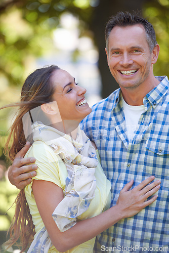 Image of Her feelings for him are true. An affectionate couple outside on a summers day.