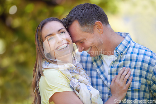 Image of Sharing loving moments outdoors. Portrait of an affectionate couple outside in the summer sun.