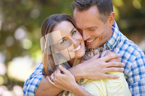 Image of They love spending time outdoors. Shot of an affectionate couple enjoying the summer sun.