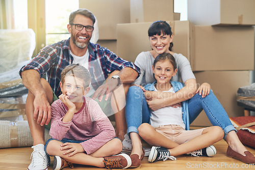 Image of Home - a place of love and happiness. Portrait of a happy family spending time together in their home on moving day.