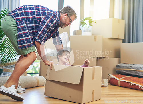 Image of Filling every room with fun memories. Shot of a happy father and son having fun together on moving day.