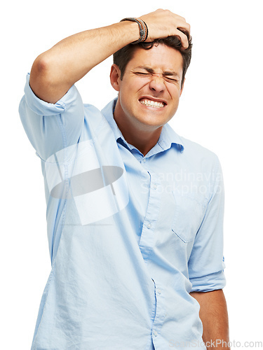 Image of Suffering from self loathing. A handsome young man holding his head in pain against a white background.