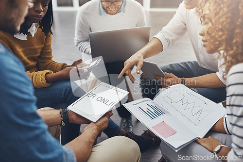 Image of Social media is the key to success. High angle shot of unrecognizable colleagues having a meeting in the office.