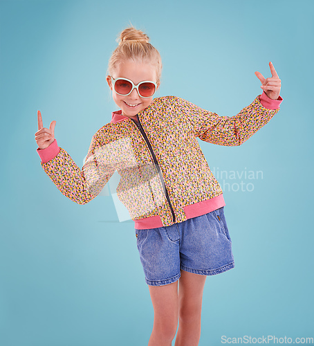 Image of Showing off my funky moves. Studio shot of a little girl wearing funky glasses on a blue background.