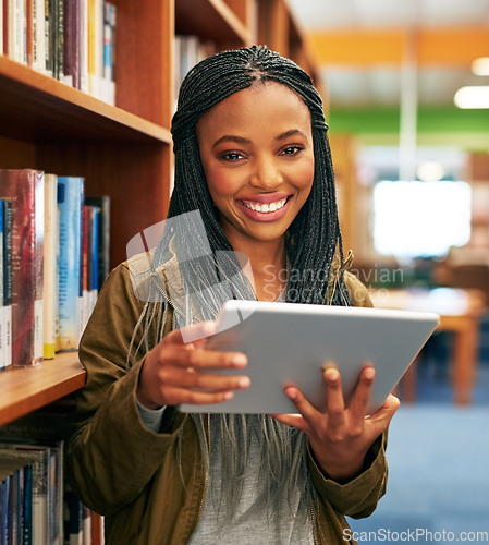 Image of Its like holding hundreds of books in my hands. Portrait of a university student using a digital tablet in the library at campus.