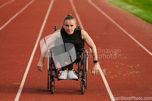 Image of A woman with disablity driving a wheelchair on a track while preparing for the Paralympic Games