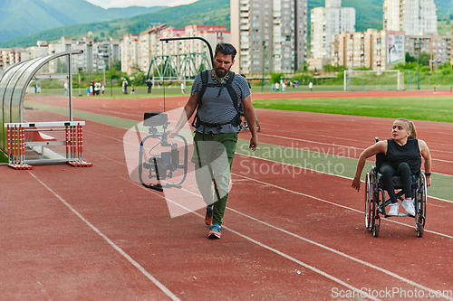 Image of A cameraman filming the participants of the Paralympic race on the marathon course