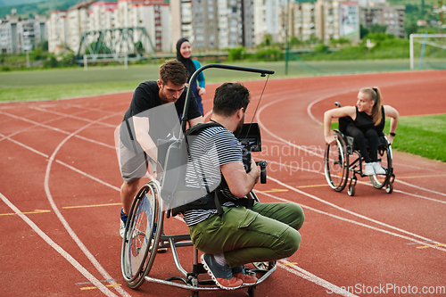 Image of A cameraman filming the participants of the Paralympic race on the marathon course