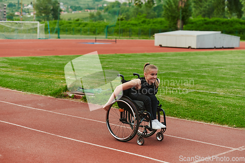 Image of A woman with disablity driving a wheelchair on a track while preparing for the Paralympic Games