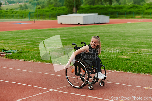 Image of A woman with disablity driving a wheelchair on a track while preparing for the Paralympic Games