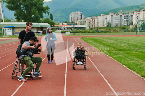 Image of A cameraman filming the participants of the Paralympic race on the marathon course