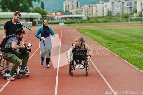 Image of A cameraman filming the participants of the Paralympic race on the marathon course