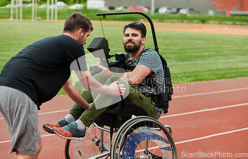 Image of A cameraman filming the participants of the Paralympic race on the marathon course