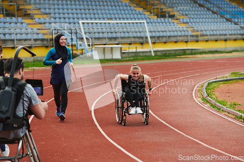 Image of A cameraman filming the participants of the Paralympic race on the marathon course