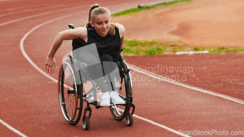 Image of A woman with disablity driving a wheelchair on a track while preparing for the Paralympic Games