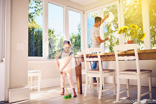 Image of Helping Dad with some spring cleaning around the house. Shot of a father and his little daughter doing chores together at home.