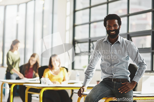 Image of This is where we make success happen. Portrait of a businessman in an office with his colleagues in the background.