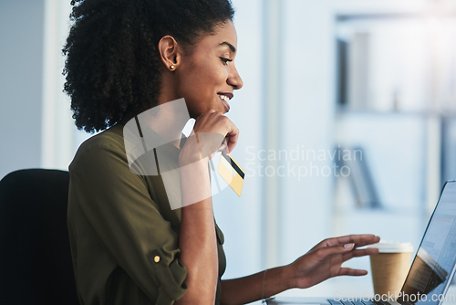 Image of Online shopping made easier just for you. Shot of a young businesswoman using her laptop and credit card in a modern office.