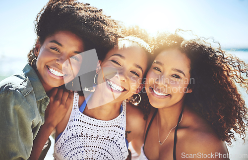 Image of Were happiest when were together. Cropped shot of three friends enjoying themselves at the beach on a sunny day.